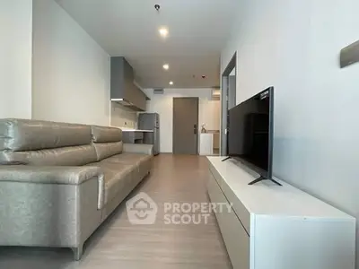 Modern living room with sleek furniture and open kitchen layout