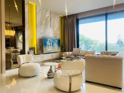 Luxurious living room with elegant decor and large windows offering a stunning view.