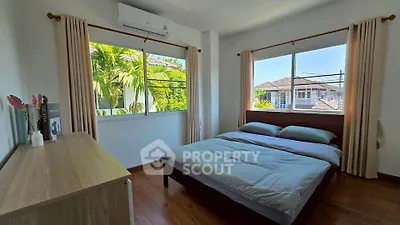 Bright and airy bedroom with large windows and modern decor