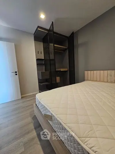 Modern bedroom with stylish open wardrobe and comfortable bed