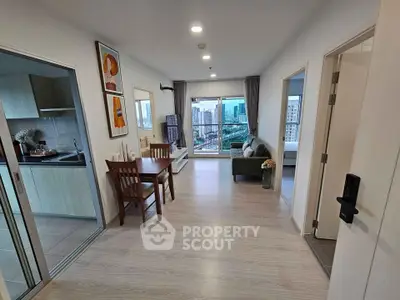 Modern apartment interior with open layout, featuring a cozy living room and kitchen with city view.