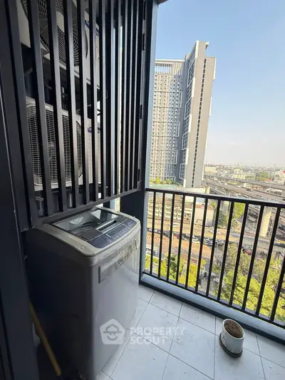 High-rise balcony with city view and washing machine, perfect for urban living.