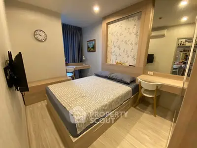 Modern bedroom with stylish decor and workspace, ideal for urban living.