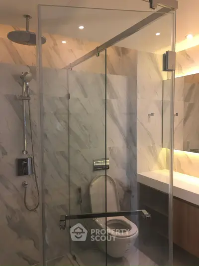 Luxurious modern bathroom with glass shower and elegant marble tiles