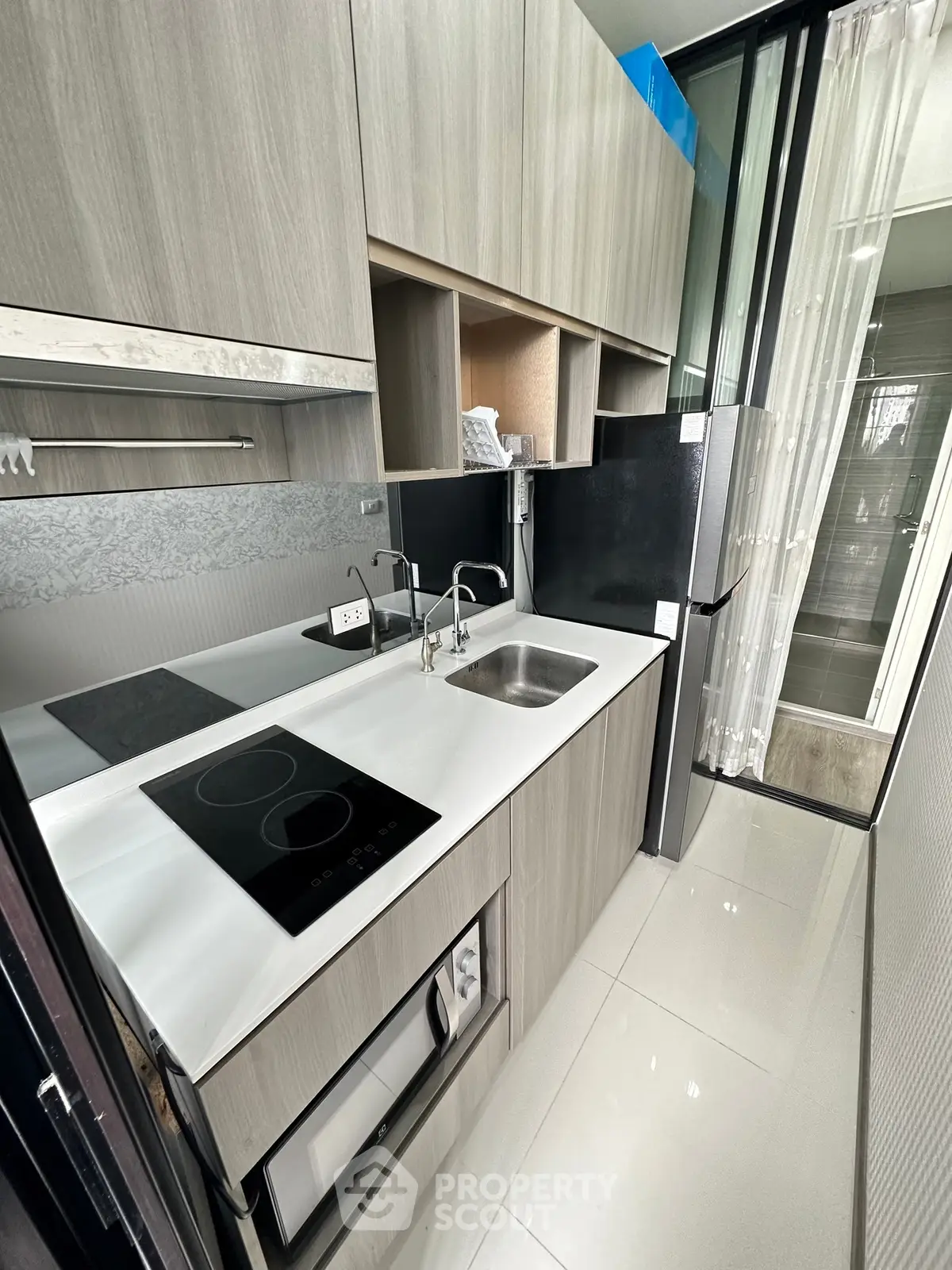 Modern compact kitchen with sleek cabinetry and built-in appliances
