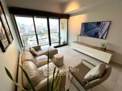 Modern living room with city view, stylish furniture, and large windows in urban apartment.