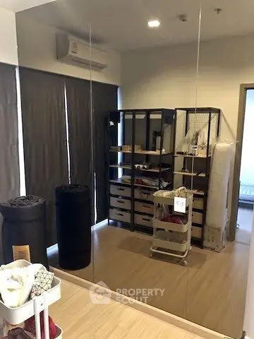 Spacious storage room with mirrored wall and organized shelving units.