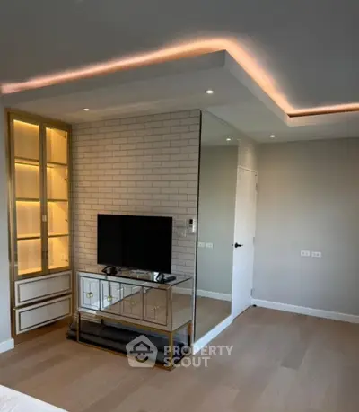 Modern living room with sleek TV setup and elegant lighting