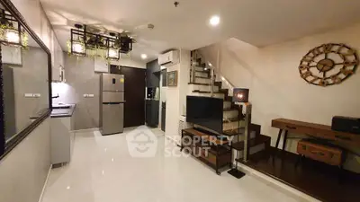 Modern living room with stylish decor and open kitchen layout in a contemporary apartment.