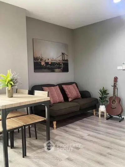 Chic living room with modern decor, cozy sofa, and stylish dining area, perfect for urban living.
