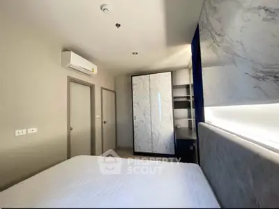 Modern bedroom with marble accents and sleek design in a stylish apartment.