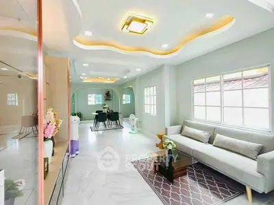 Spacious modern living room with elegant ceiling design and cozy seating area.