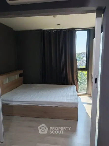 Modern bedroom with large window and minimalist design