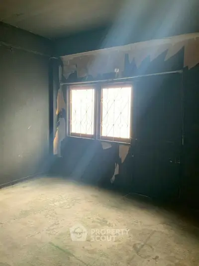 Spacious room with natural light and potential for renovation.