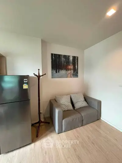 Cozy living room with modern decor and compact fridge, perfect for urban living.