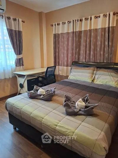 Cozy bedroom with modern decor and natural light, perfect for relaxation.