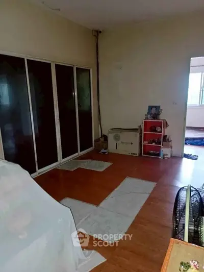 Spacious living room with sliding glass doors and wooden flooring, ideal for cozy gatherings.