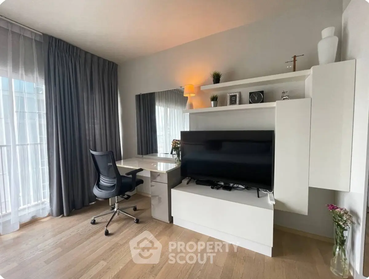 Modern study room with sleek desk, ergonomic chair, and large TV, perfect for productivity and relaxation.