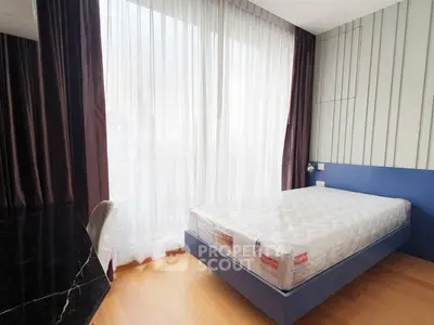 Modern bedroom with large window and minimalist design, featuring a new mattress and elegant curtains.