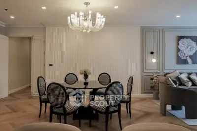 Elegant living room with chic dining area and modern chandelier