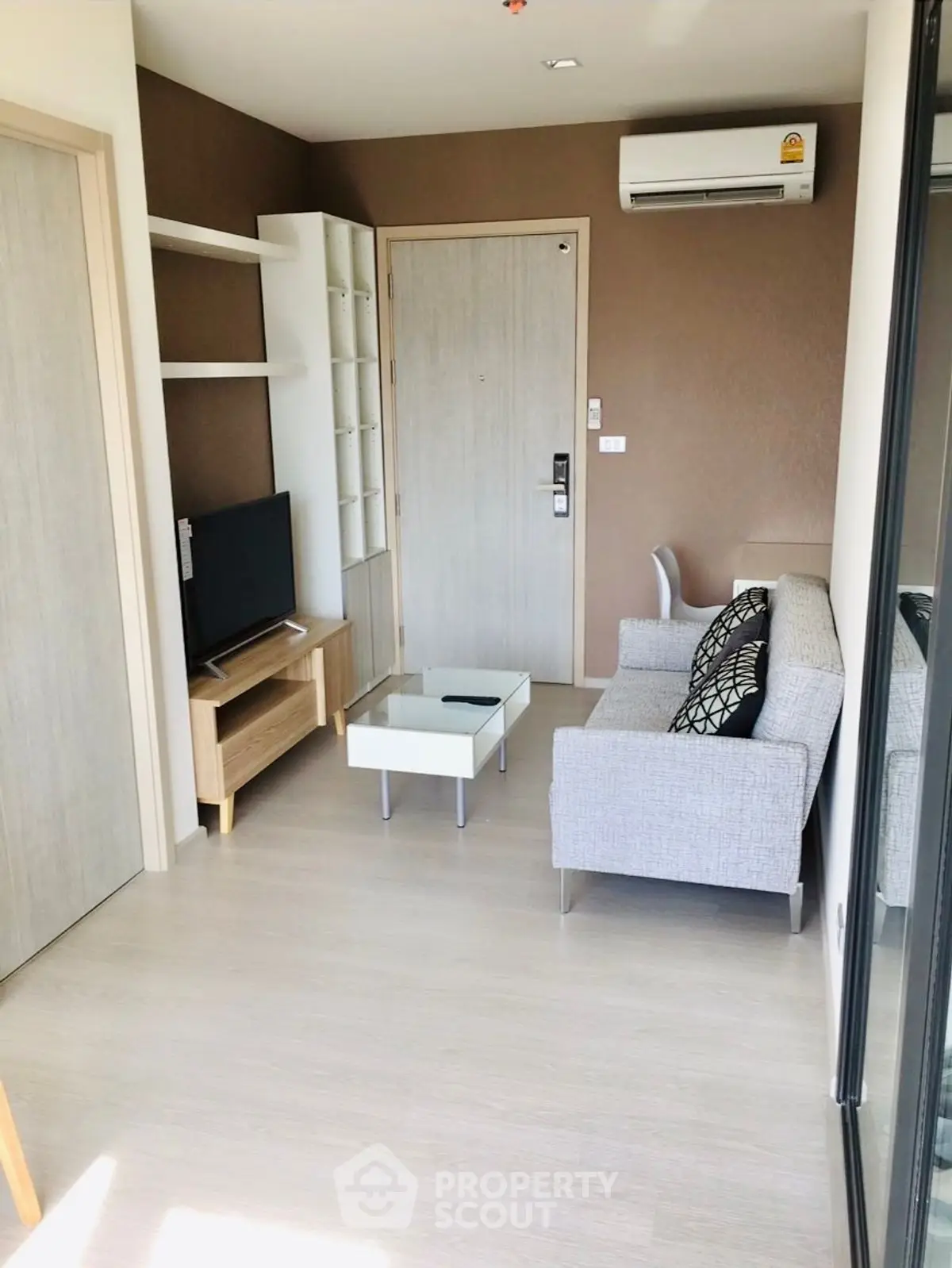 Modern living room with sleek furniture and air conditioning in a stylish apartment.