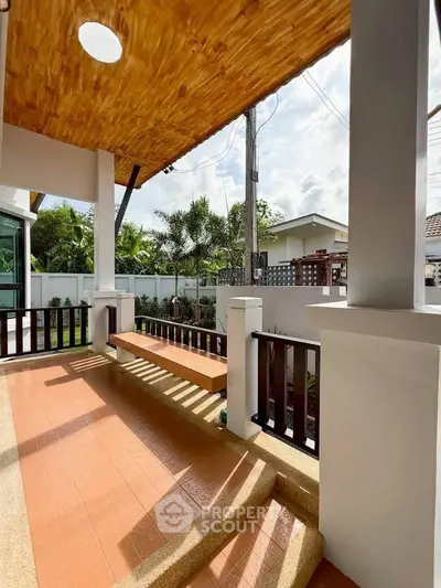 Charming outdoor porch with wooden ceiling and garden view