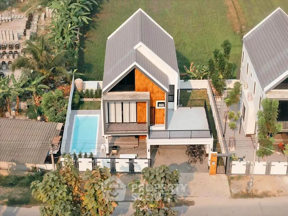 Modern two-story house with pool and spacious balcony in lush green setting