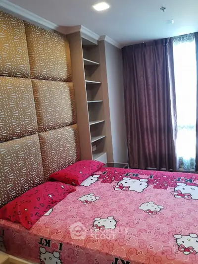 Charming bedroom with playful decor and ample natural light, perfect for a cozy retreat.