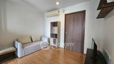 Modern living room with wooden flooring and minimalist furniture