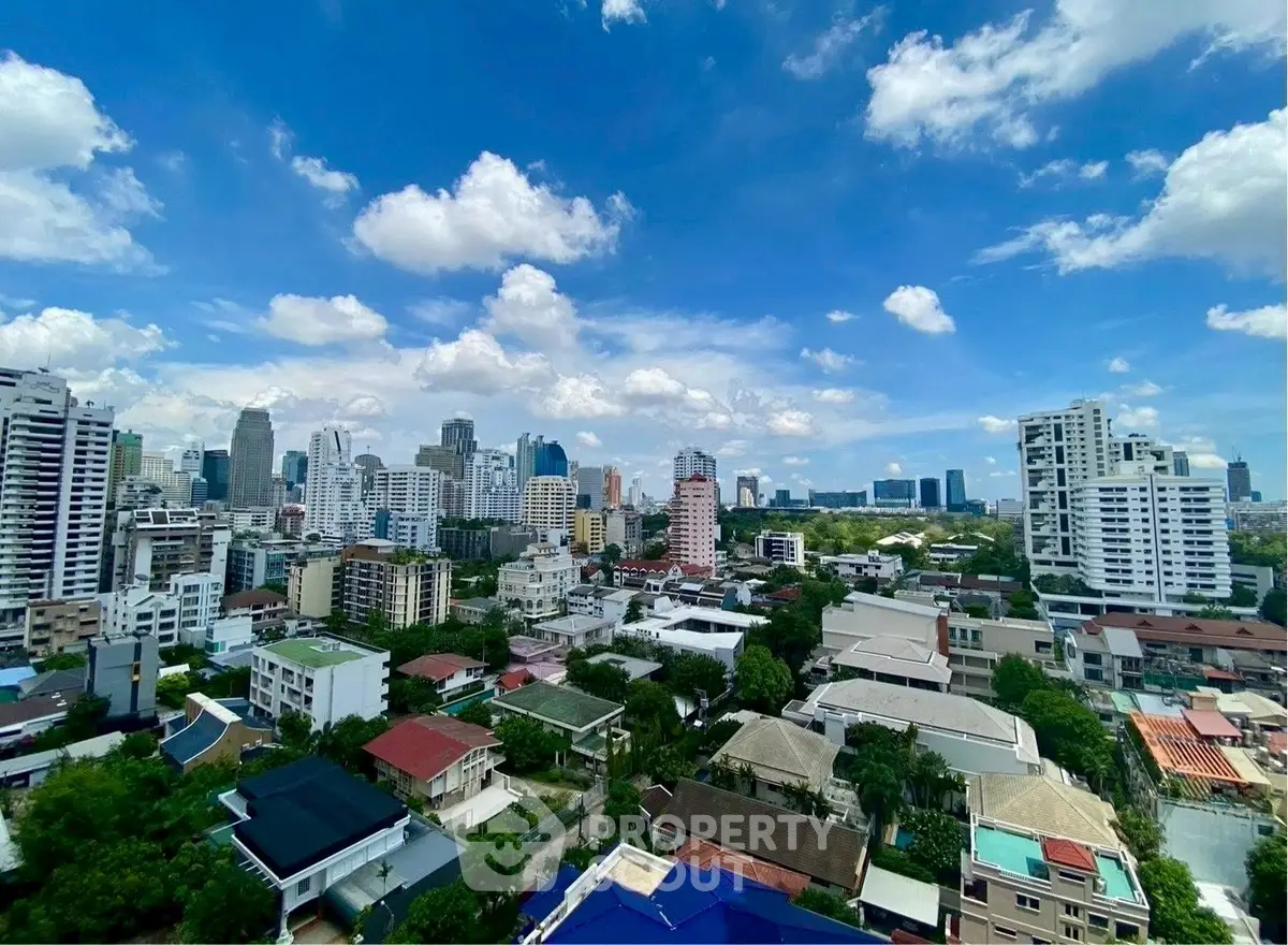 Stunning cityscape view showcasing urban skyline and residential buildings under a vibrant blue sky.
