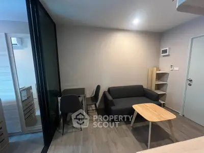 Modern living room with sleek furniture and cozy ambiance in a stylish apartment.
