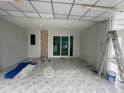 Spacious interior with modern tiled flooring and sliding glass doors, ideal for versatile living space.