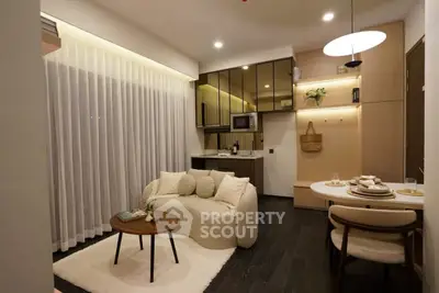 Modern living room with cozy seating and stylish kitchen in open layout apartment.