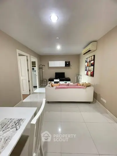 Modern living room with sleek white furniture and stylish decor