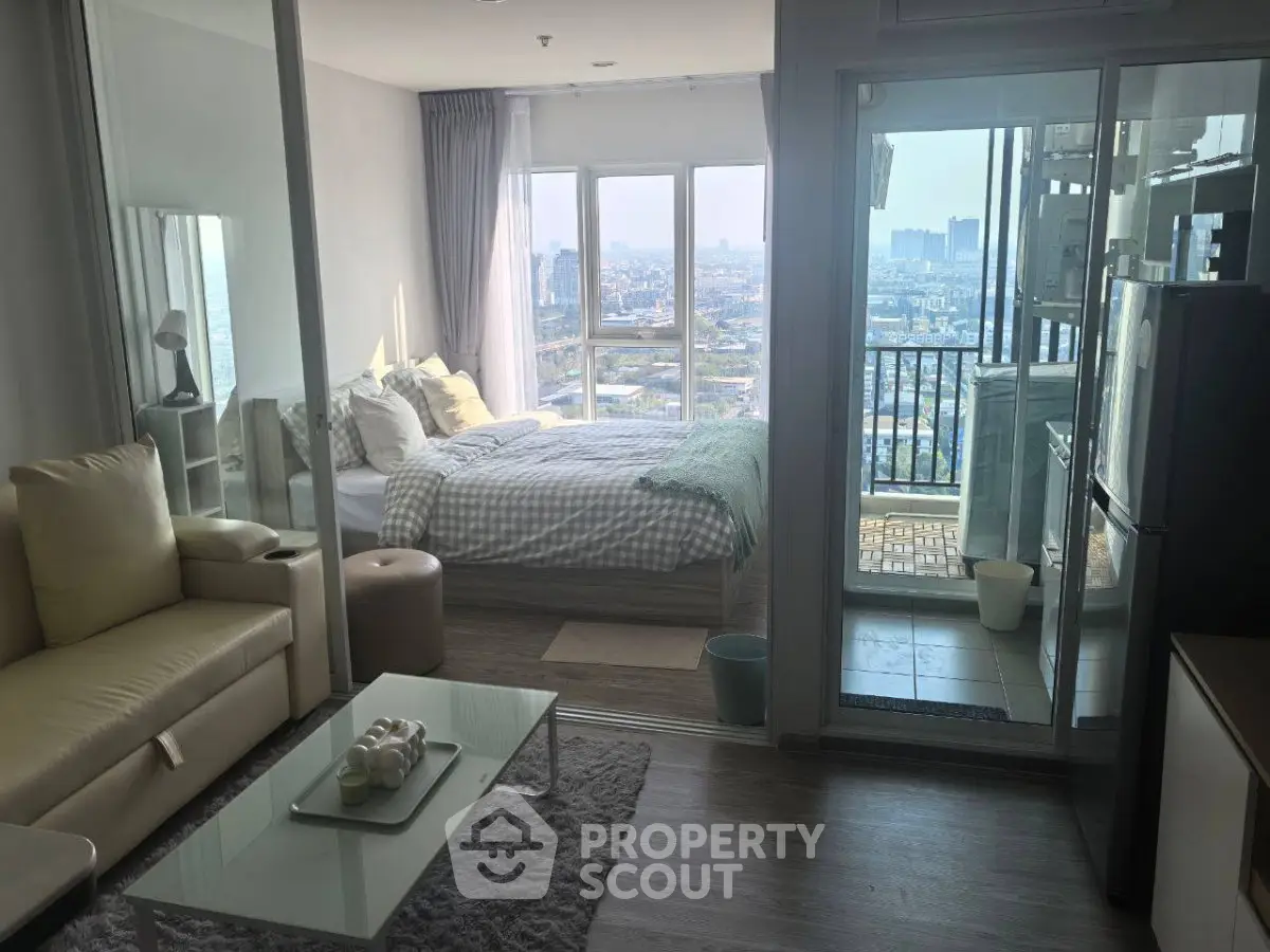 Modern apartment with stunning city view, featuring cozy living room and bedroom with balcony access.
