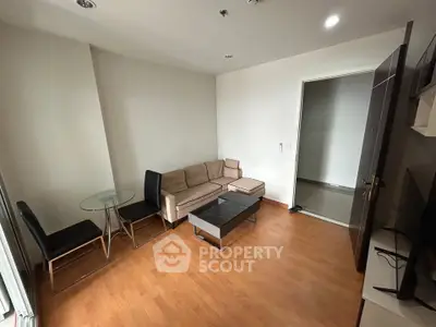 Cozy living room with modern furniture and wooden flooring in a stylish apartment.