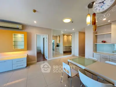 Spacious modern living room with open layout and elegant dining area, featuring stylish furniture and bright lighting.