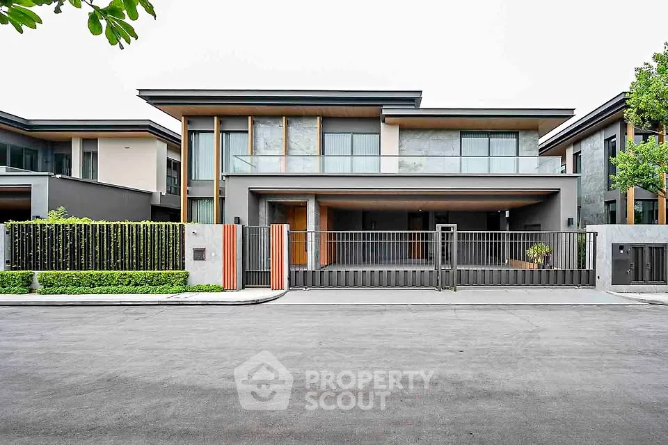 Modern luxury home with sleek design and spacious driveway in upscale neighborhood.