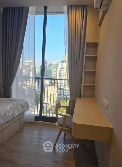 Modern bedroom with city view and stylish wooden desk