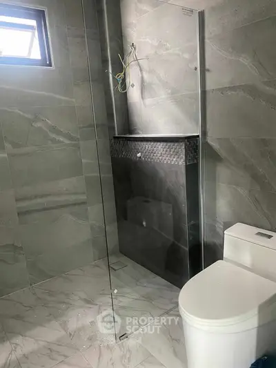 Modern bathroom with sleek glass shower and marble tiles