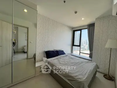 Modern bedroom with city view, featuring a cozy bed and stylish decor.