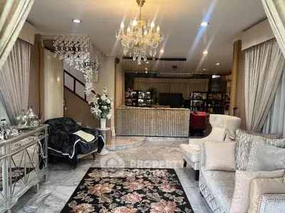 Luxurious living room with elegant chandelier and plush seating, perfect for sophisticated gatherings.