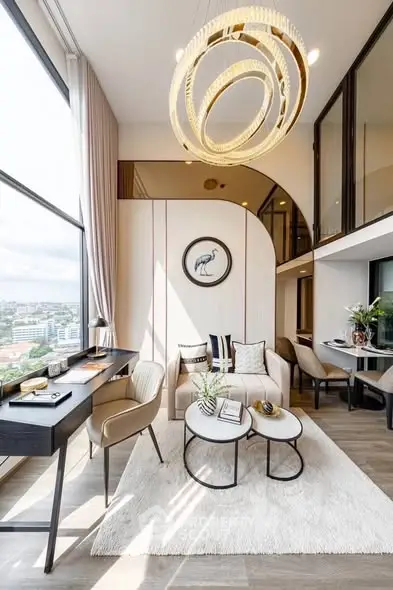 Luxurious modern living room with high ceilings, elegant chandelier, and large windows offering stunning city views.