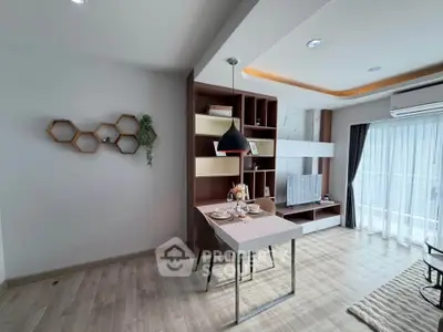 Modern living room with stylish decor and natural light, featuring a dining area and TV setup.