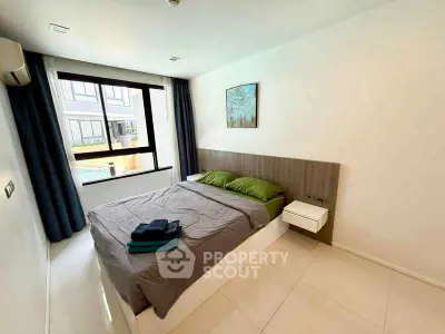 Modern bedroom with large window and pool view in stylish apartment