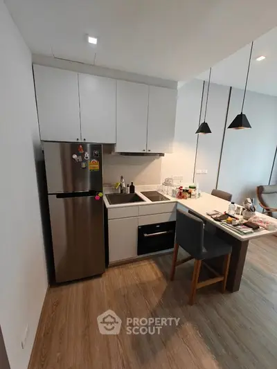 Modern kitchen with sleek appliances and open layout in stylish apartment