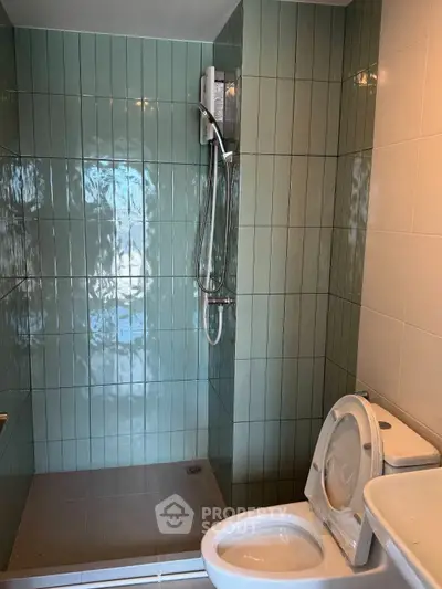 Modern bathroom with sleek shower and toilet in contemporary design.