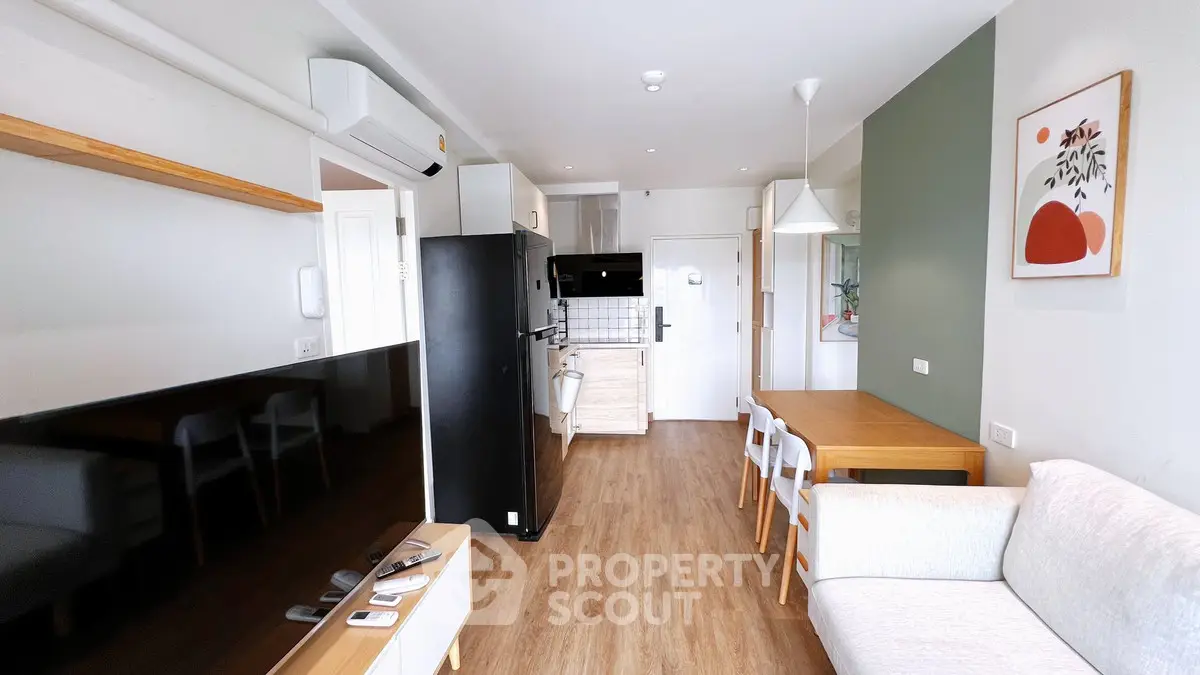 Modern open-plan living room with stylish decor and kitchen area