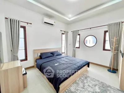 Spacious modern bedroom with stylish decor and natural light