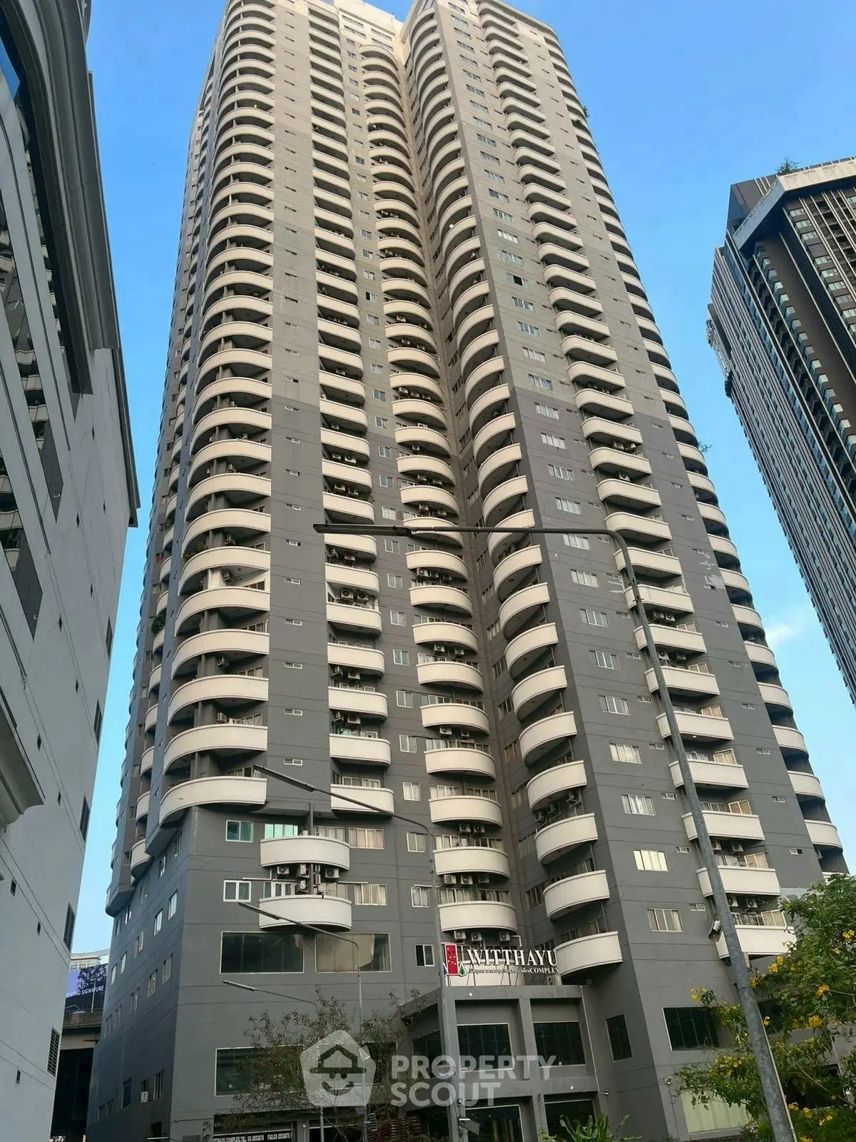 Stunning high-rise building with modern architecture and spacious balconies in urban setting.